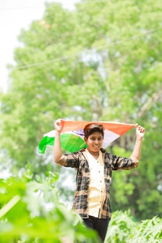 Indian boy holding national flag in farm, happy boy, national flag photo