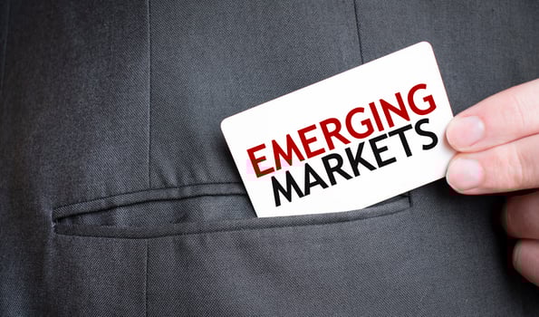 Card with EMERGING MARKETS text in pocket of businessman suit. Investment and decisions business concept. photo