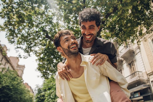 Happy gay couple kissing in the park. LGBT gay couple concept. photo