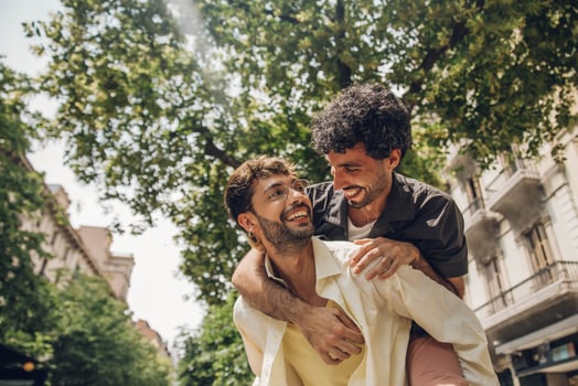Happy gay couple kissing in the park. LGBT gay couple concept. photo