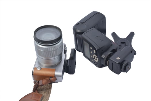 mirrorless camera and flash trigger isolated white background photo