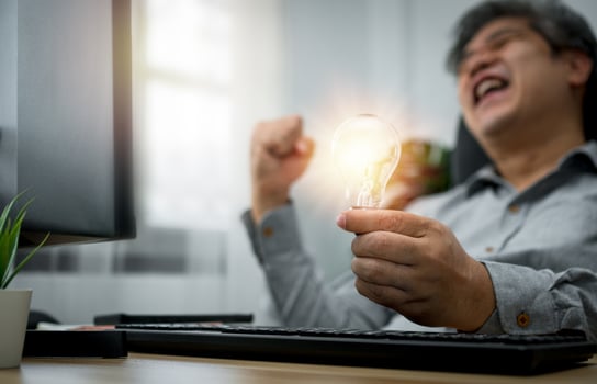Businessman holding lightbulb and feeling delighted and excited by new innovation and ideas for success business panels.Concept of innovation creative technology ideas for Business solution photo
