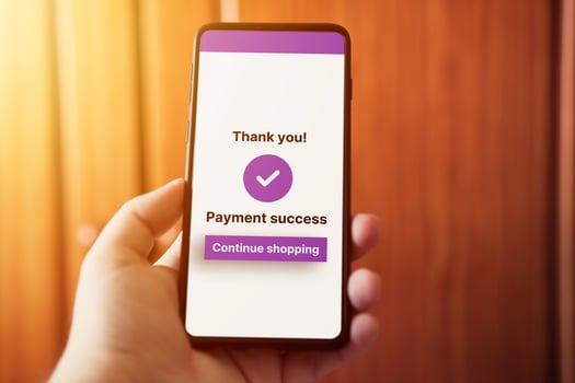 Woman use smartphone to pay online purchase. Online shopping concept. Secure payment on internet. Payment success on screen. Selective focus. photo