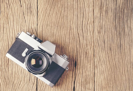vintage old film camera on wood board photo