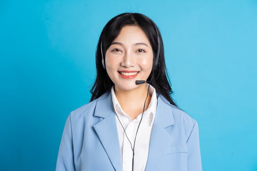 portrait of asian business woman posing on blue background photo