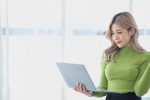 Portrait of a woman business owner showing a happy smiling face as he has successfully invested in her business using tablets and financial budget documents at work. photo