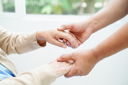 Caregiver holding hands Asian elderly woman patient, help and care in hospital. photo