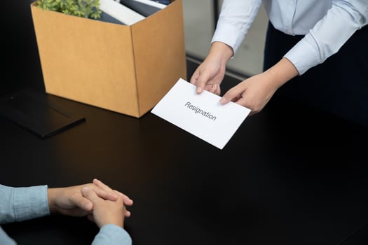 Business woman sending resignation letter to boss and Holding Stuff Resign Depress or carrying cardboard box by desk in office photo