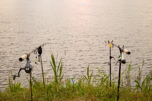 Fisherman's Fishing Rods, Catches Fish on a Foggy Sunrise. Fishing Concepts photo
