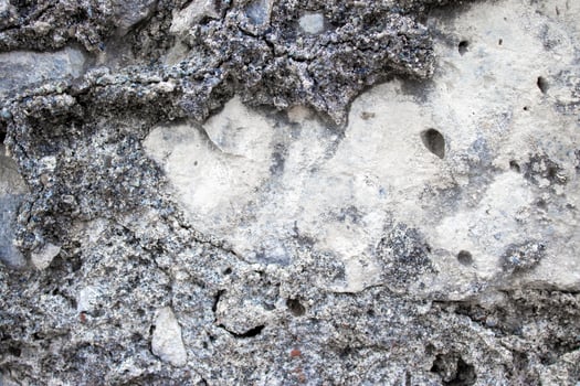 Ancient Stone Wall. Abstract Cement Background. The Texture of the Ancient Stone From Pebbles, Stones and Bricks Close-up photo