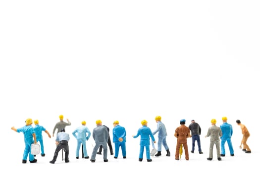 Miniature people , Worker team standing on white background, Labour day concept photo