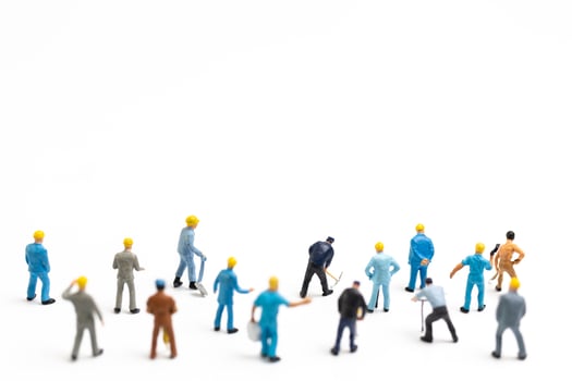 Miniature people , Worker team standing on white background, Labour day concept photo