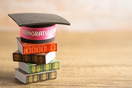 Graduation hat on book with copy space, learning university education concept. photo