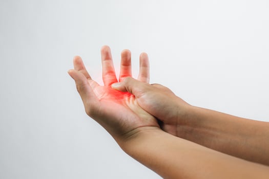 A male patient suffering from joint, finger pain and numbness, depicting a medical symptom, against a white background. photo