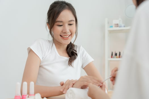 Woman receive care service by professional Beautician Manicure at spa centre. Nail beauty salon use nail file for Glazing treatment. manicurist make nail customer to beautiful. body care spa treatment photo
