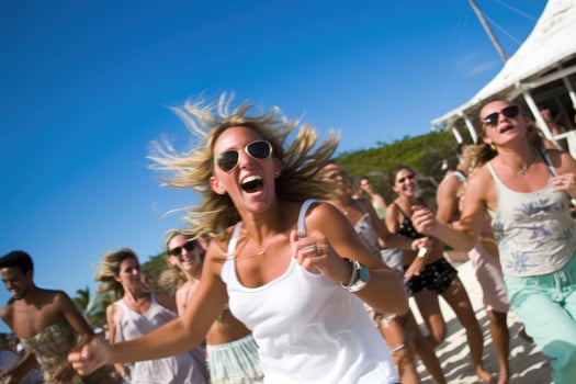 Beach club party, with people dancing and enjoying the music under the warm sun. photo