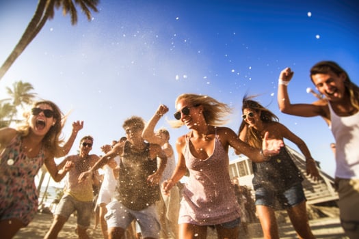 Beach club party, with people dancing and enjoying the music under the warm sun. photo