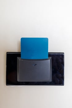 Hotel keycard in electronic lock on the wall. Plastic entry key card inserted in a room switch. photo