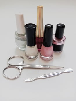 colorful nail polishes, scissors, manicure equipment photo