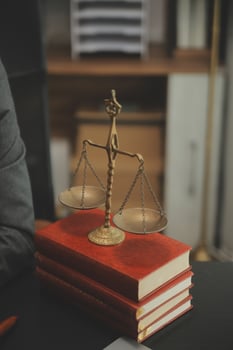 Business and lawyers discussing contract papers with brass scale on desk in office. Law, legal services, advice, justice and law concept picture with film grain effect photo