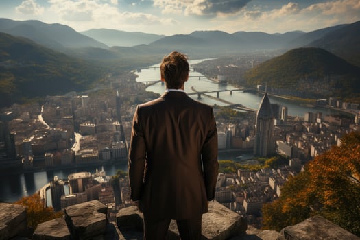 A businessman standing alone on the rooftop of a skyscraper, his back turned to the camera as he overlooks the city. photo
