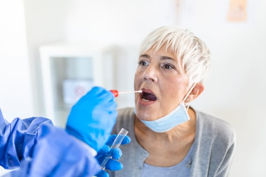 Physician wearing personal protective equipment performing a Coronavirus COVID-19 PCR test, patient nasal NP and oral OP swab sample specimen collection process, viral rt-PCR DNA diagnostic procedure photo