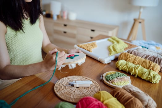 Punch needle. Asian Woman making handmade Hobby knitting in studio workshop. designer workplace Handmade craft project DIY embroidery concept. photo