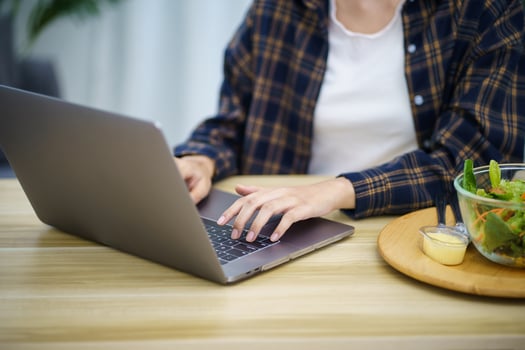 Happy beautiful Asian woman using computer laptop for work online at living room photo