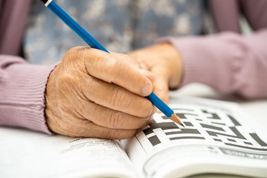 Alzheimer disease AD, Asian elderly woman playing sudoku puzzle game to practice brain training for dementia prevention. photo