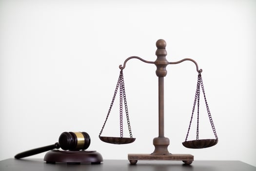 gavel wood and Brass court scales are used to decorate a table in a legal advisor office for aesthetic reasons ,Because the brass court scales are a symbol of justice. legal advisor concept. photo
