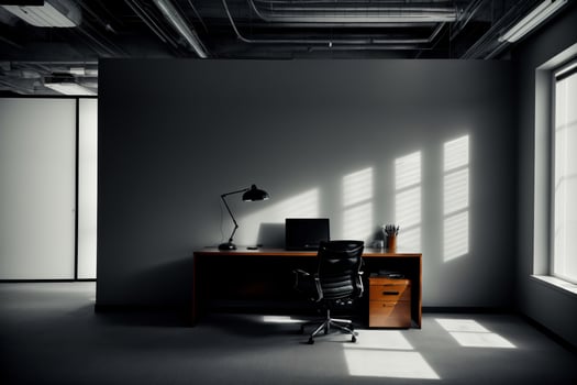 A Black And White Photo Of A Desk In An Office.