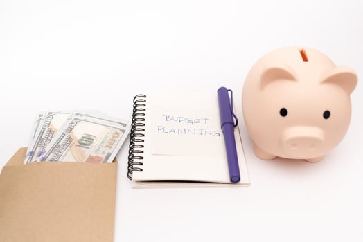 Money budget planning. Piggy bank with calculator and notebooks on white background, financial goal concept. photo