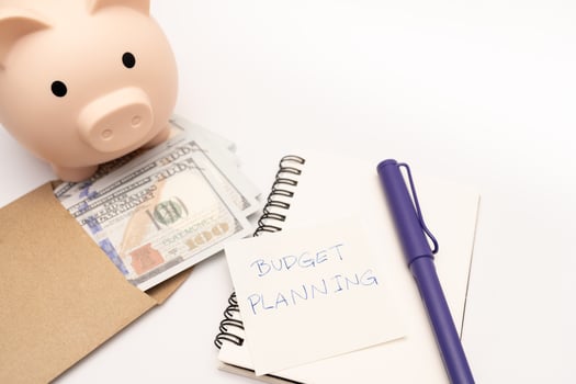 Money budget planning. Piggy bank with calculator and notebooks on white background, financial goal concept. photo