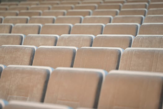 A row of empty beige chairs in the auditorium. photo