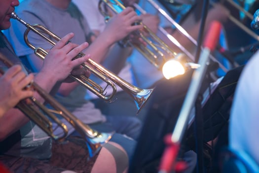 Belarus, the city of Gomel, June 25, 2021. Central office in the area.A group of musicians are playing on shiny trumpets. Musical symphony or jazz concert. photo