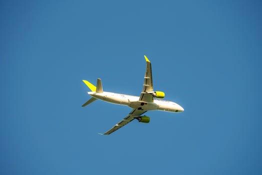 White passenger airplane flying in the sky amazing clouds in the background. Travel by air transport photo