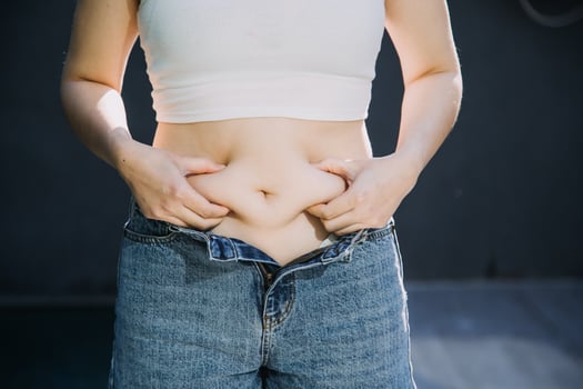 fat woman, fat belly, chubby, obese woman hand holding excessive belly fat with measure tape, woman diet lifestyle concept photo