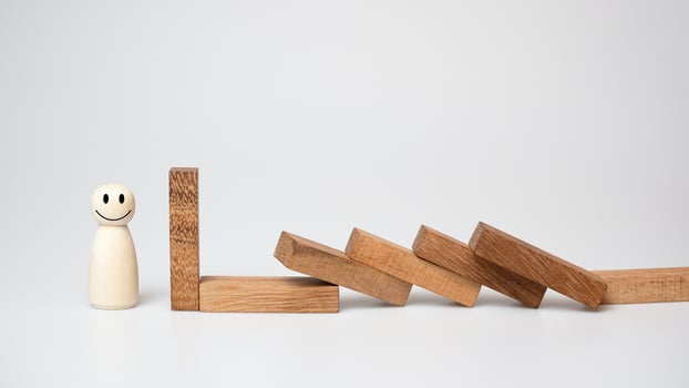 Risk management concept. Wooden block stopping dominoes effect for business. photo