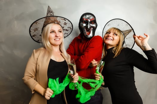 Halloween witches and vampires having cocktail party in bar photo