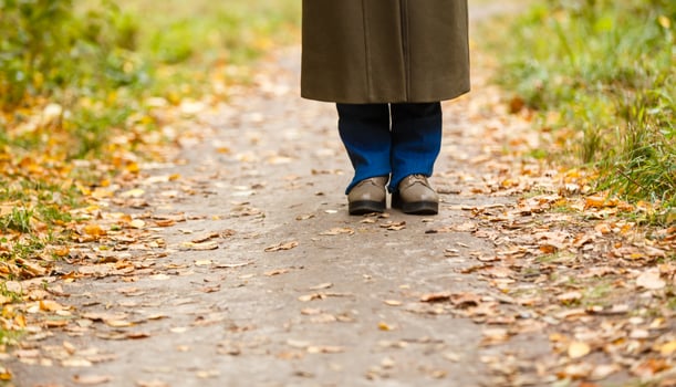Woman walking cross country and trail in autumn forest photo