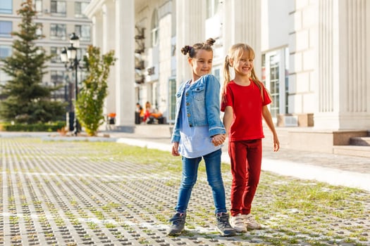 Portrait of happy fashion little girls having fun in the city photo