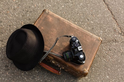 old camera and suitcase against the background of the ferris wheel photo