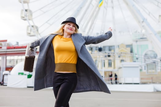 Stylish woman posing near ferris wheel photo