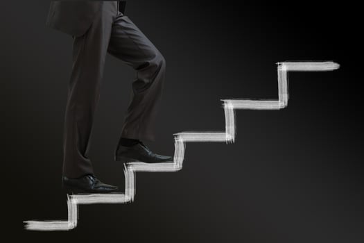 Businessman climbing career ladder photo