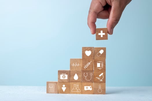 Insurance for your health and healthcare concept, Businessman hand arranging wood block stacking with icon healthcare medical. photo
