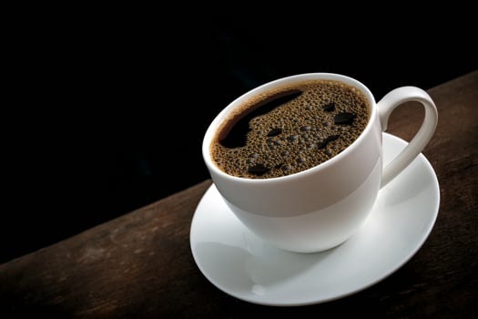 Cup of coffee on old wooden table photo