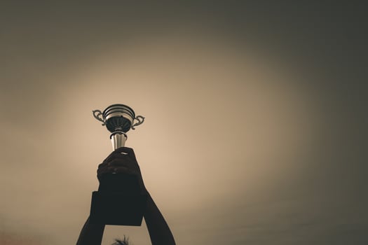 The winning athlete Raise the trophy with joy in the victory. photo