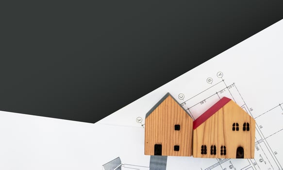 real estate and property, architecture, building, construction concept - Tiny house model on an architect's desk photo