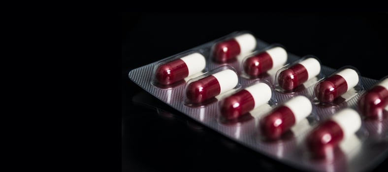 Medical concept, Drug capsule for treatment on black background. photo