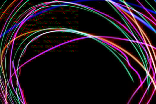 Multi color light painting photography, swirl and curve of blue, green and red light against a black background. photo